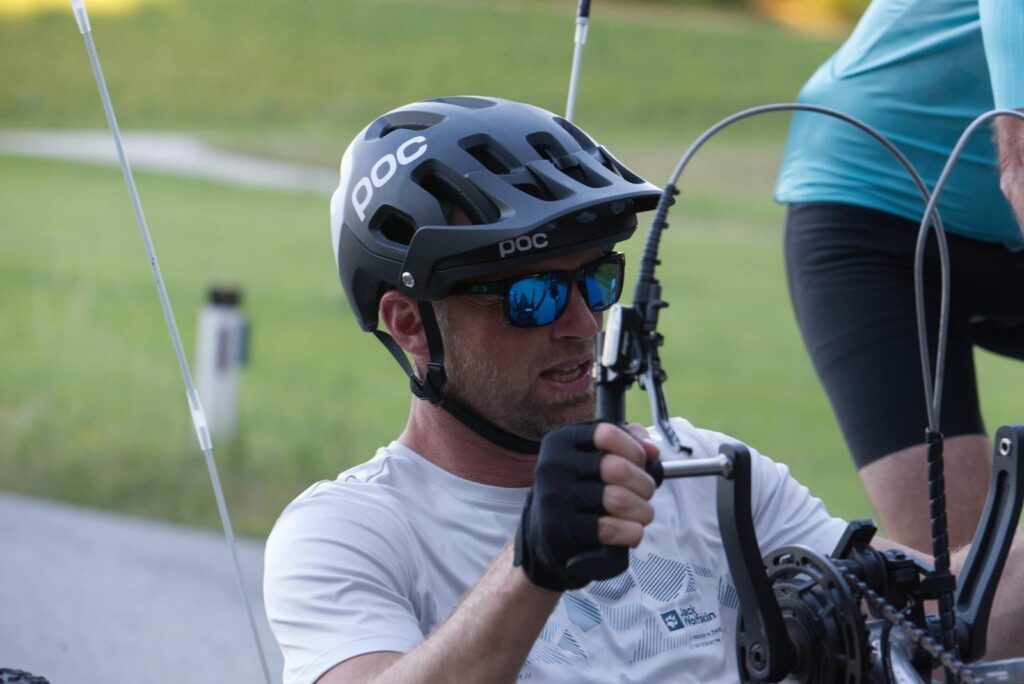 Zoomed in picture of guy biking the handbike scout